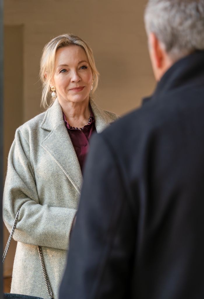close-up of woman in beige jacket