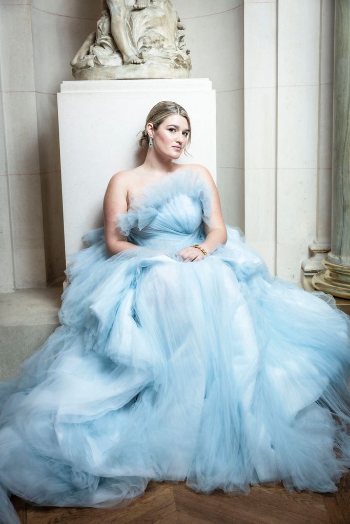 Blonde lady wearing ruffled tulle gown in powder blue