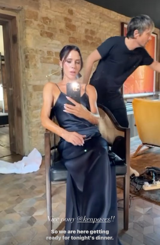 A photo of Victoria Beckham wearing a navy blue dress 