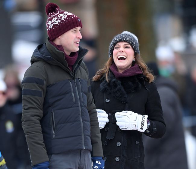 Prince William and Kate Middleton laughing in winter clothes and a beanie hat in Sweden