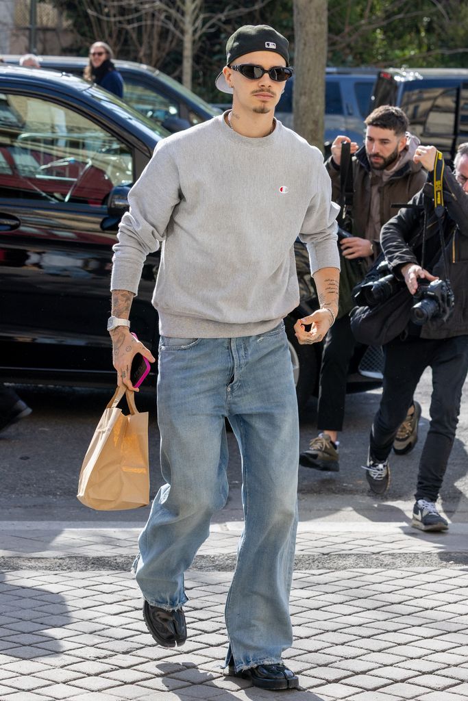 romeo beckham in grey sweatshirt and jeans