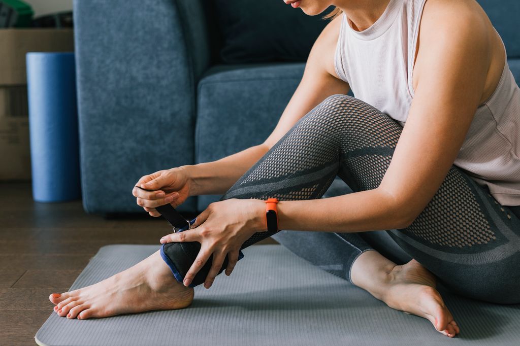 woman putting on adjustable ankle weights