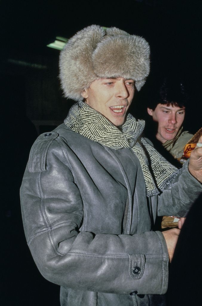 David Bowie wearing a grey leather coat and Russian-style fur ushanka hat in 1980