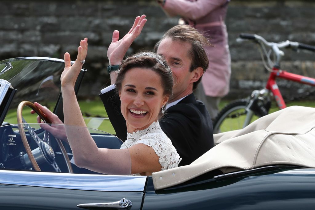 Pippa Middleton and James Matthews waving in the car following their wedding