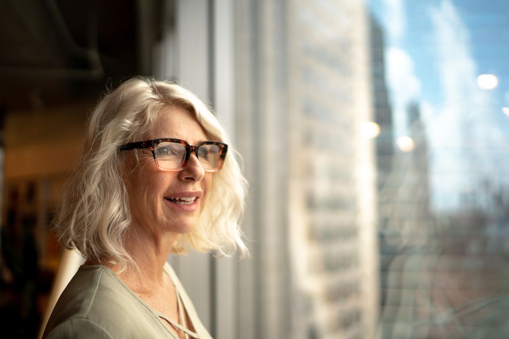 Mature businesswoman looking out of window