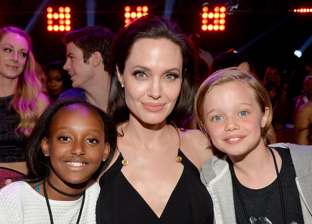 angelina jolie smiling with two children