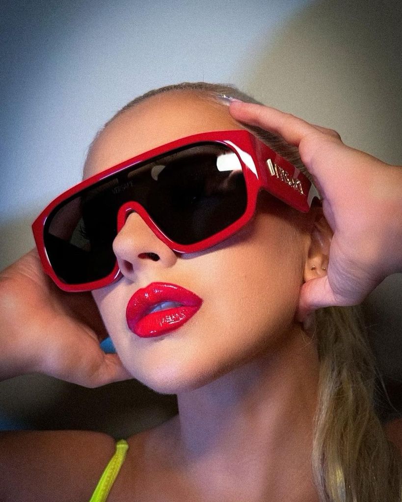 Christina Aguilera in red sunglasses