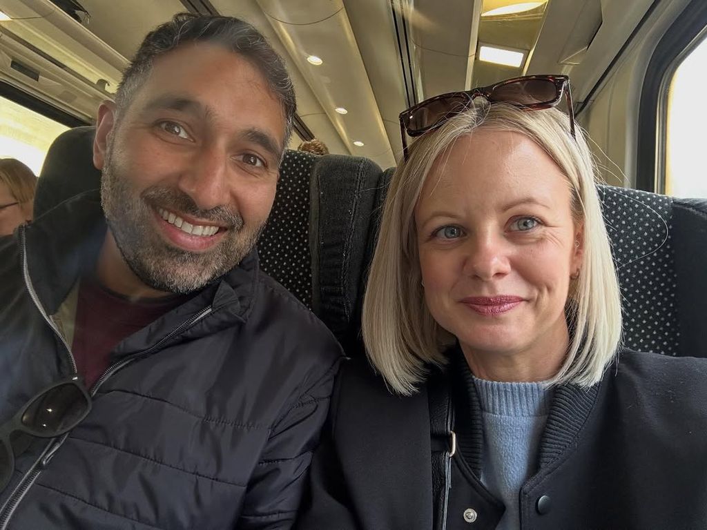 Two people sitting on a train