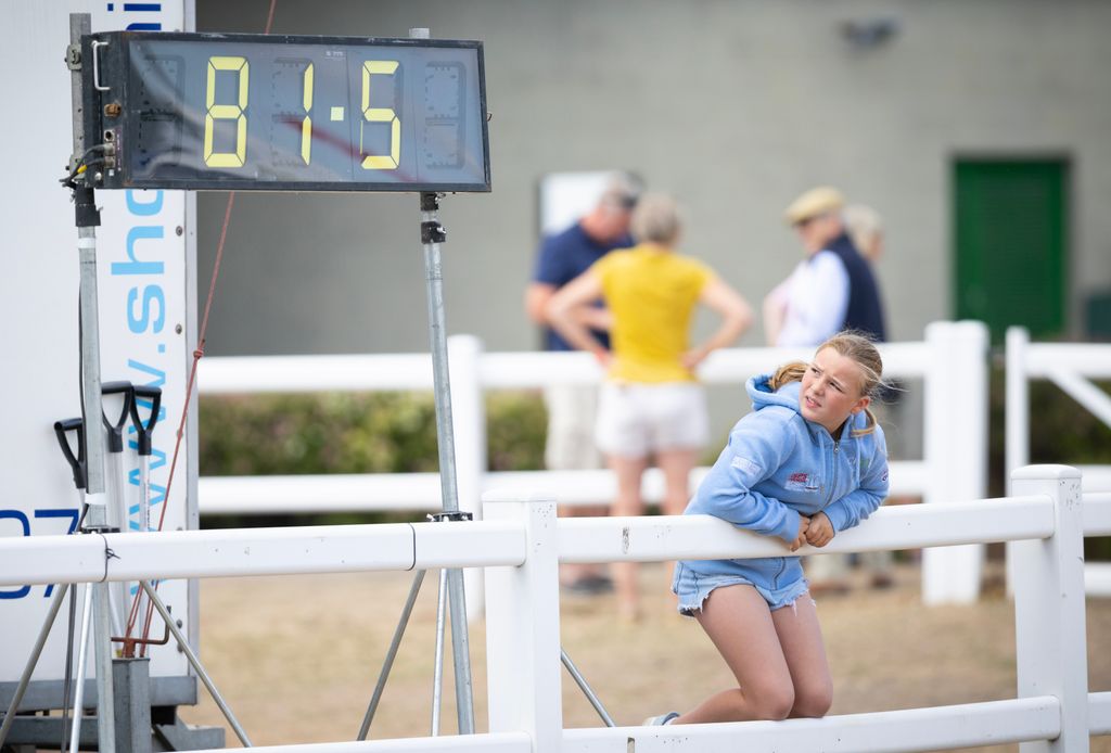 Mia Tindall looking at horse score at the hartpury horse trials