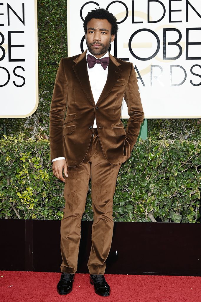 Donald Glover on red carpet in brown suit