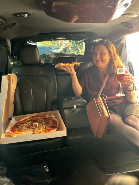 Writer Tilly enjoying a pizza in a limo
