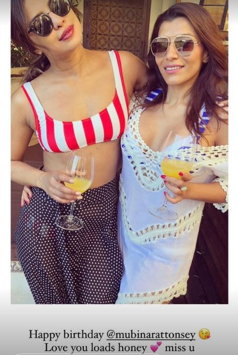 Priyanka Chopra in bikini top and skirt with a friend in a dress