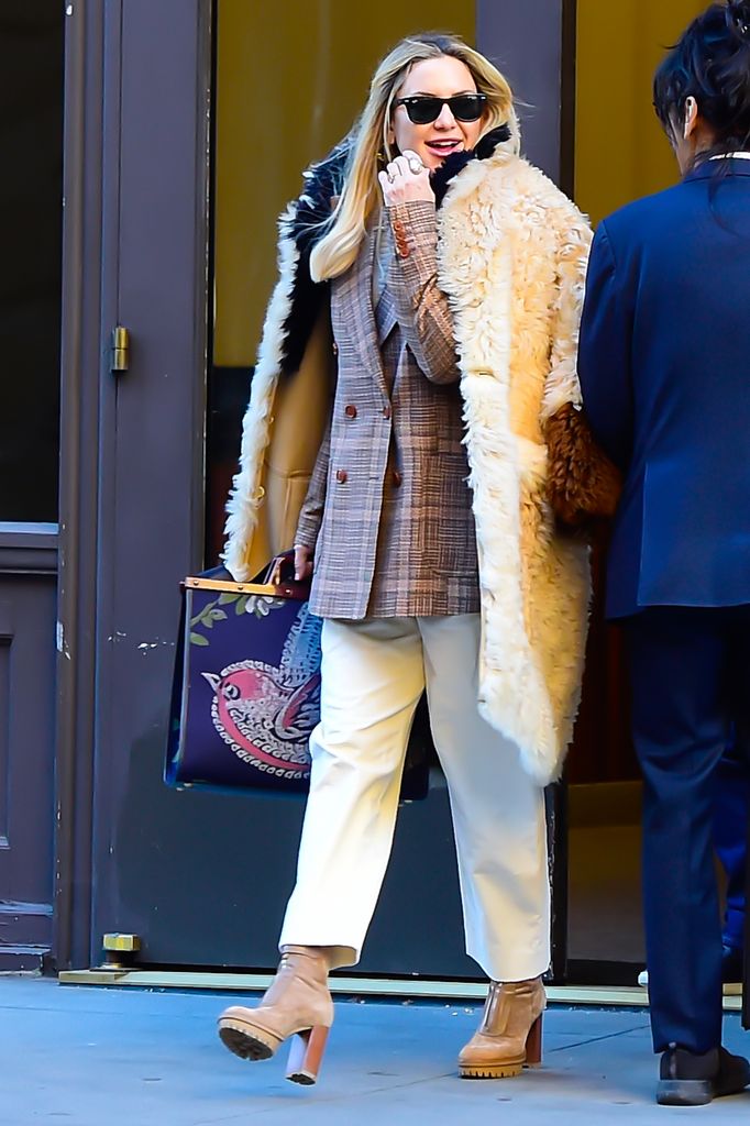 Kate in fur coat and white pants