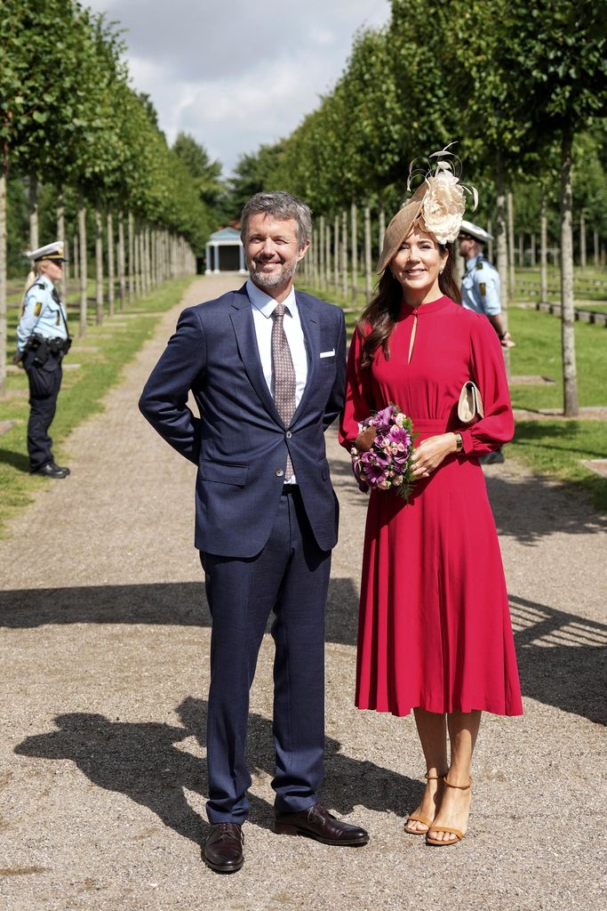 Denmark's Crown Prince Frederik and Denmark's Crown Princess Mary stand at the entry to the churchyard