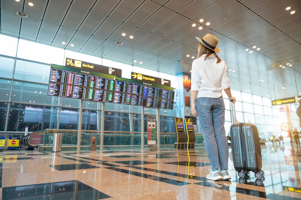 Rear tourist woman at international airport