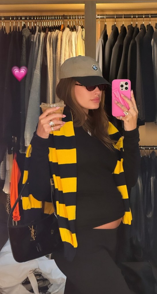 Hailey Bieber weaing a rugby-style jumper and BMW cap