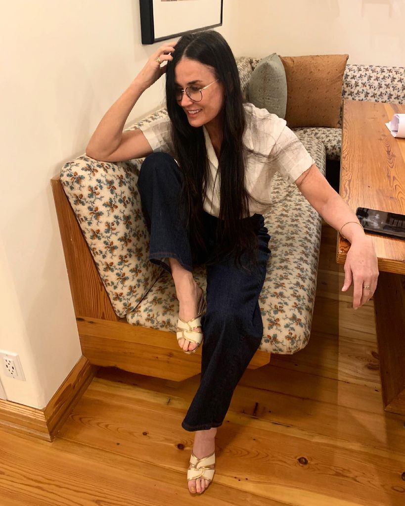 Demi Moore sitting in breakfast nook 