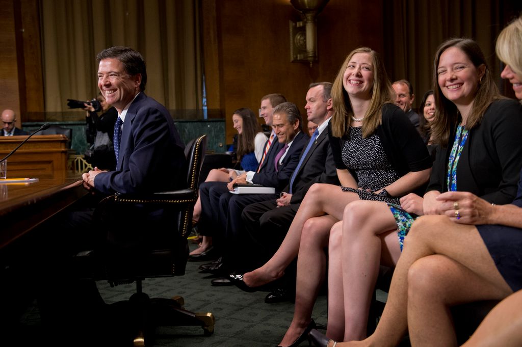James Comey, nominee for FBI Director, shares a laugh with his daughters, Kate, center, and Maureen and his wife Patrice during his conformation hearing before the a Senate Judiciary Committee 