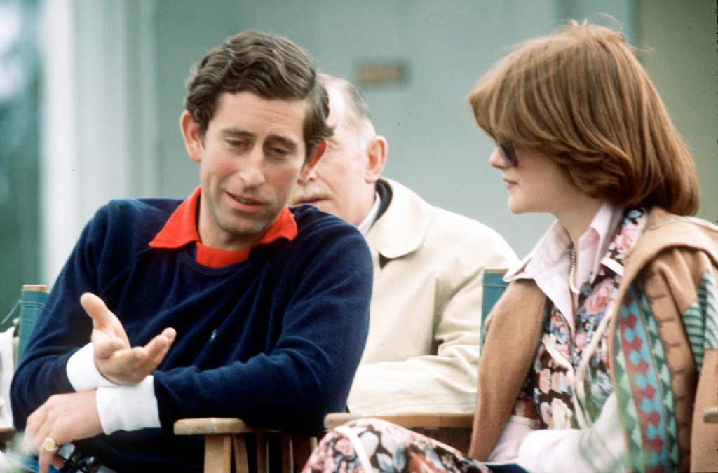 Young King Charles in a navy blue jumper chatting with young Lady Sarah 