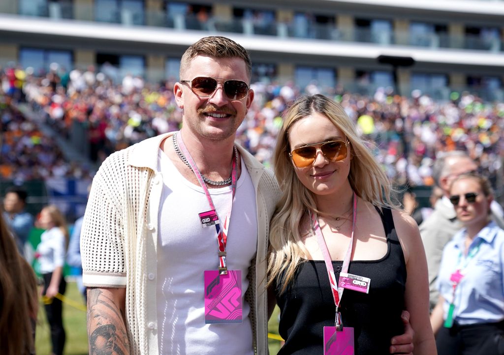 holly ramsay and adam peaty smiling outside in sunshine at silverstone 