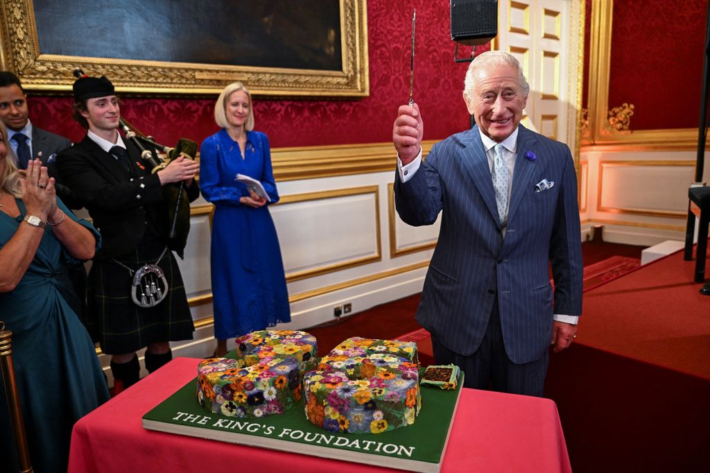 Britain's King Charles holds a knife to cut a cake during the King's Foundation Awards ceremony, on the 35th anniversary of The King's Foundation