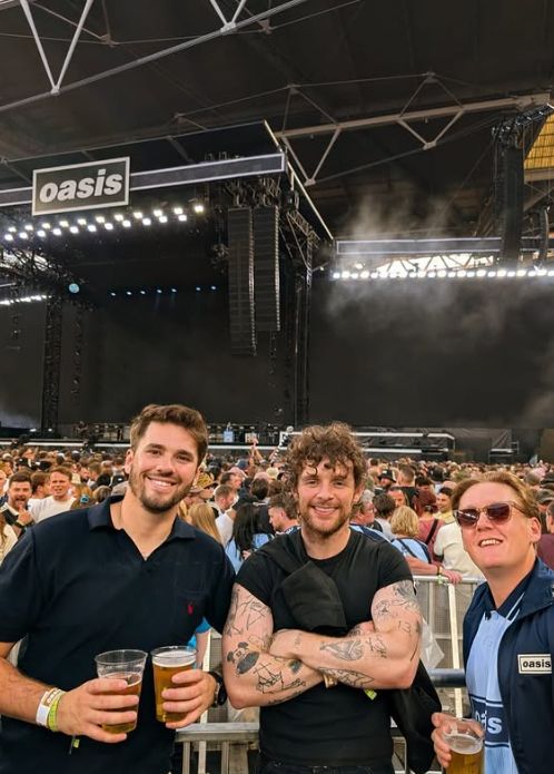 Thomas Turgoose, Tom Grennan and another male at a concert
