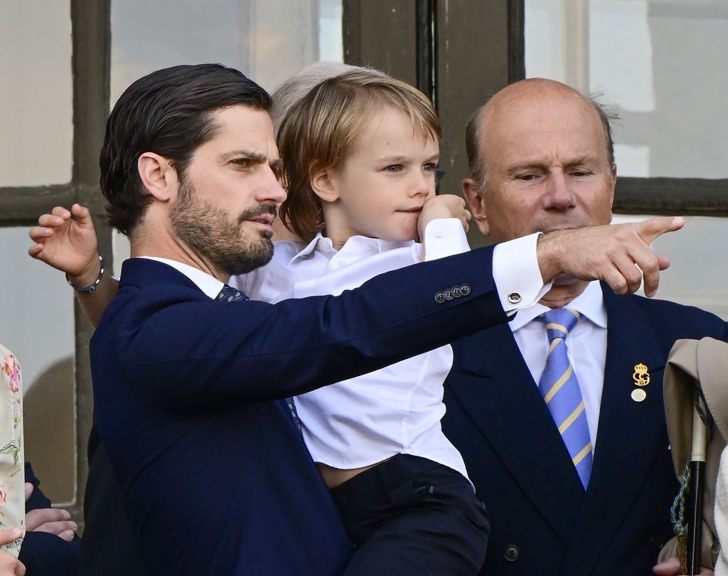 Prince Carl Philip holding Prince Gabriel