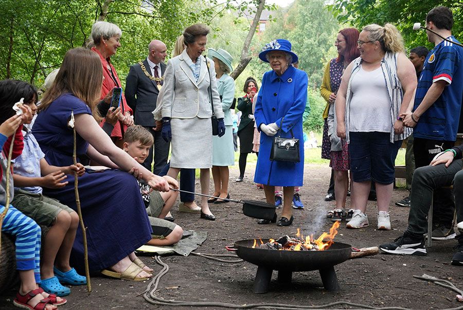 queen meet children toasting marshmallows