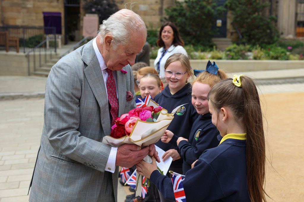 The King given flowers from schoolchildren
