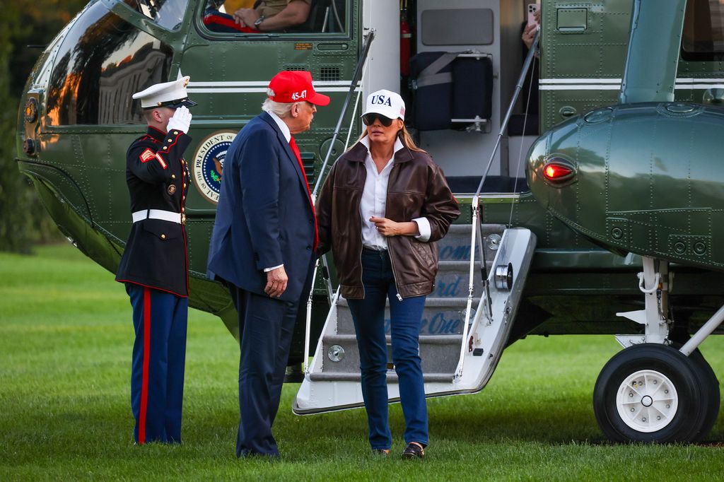 President Donald Trump and first lady Melania Trump talk after disembarking Marine One on the South Lawn of the White House