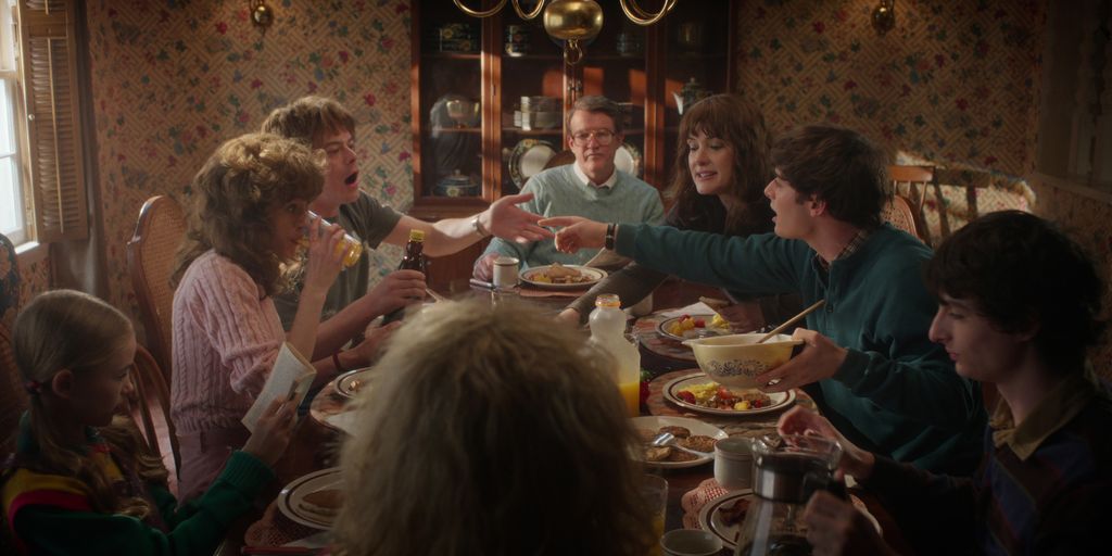 STRANGER THINGS: SEASON 5. (L to R) Nell Fisher as Holly Wheeler, Natalia Dyer as Nancy Wheeler, Charlie Heaton as Jonathan Byers, Joe Chrest as Joe Wheeler, Winona Ryder as Joyce Byers, Noah Schnapp as Will Byers, and Finn Wolfhard as Mike Wheeler in Stranger Things: Season 5. Cr. COURTESY OF NETFLIX Â© 2025