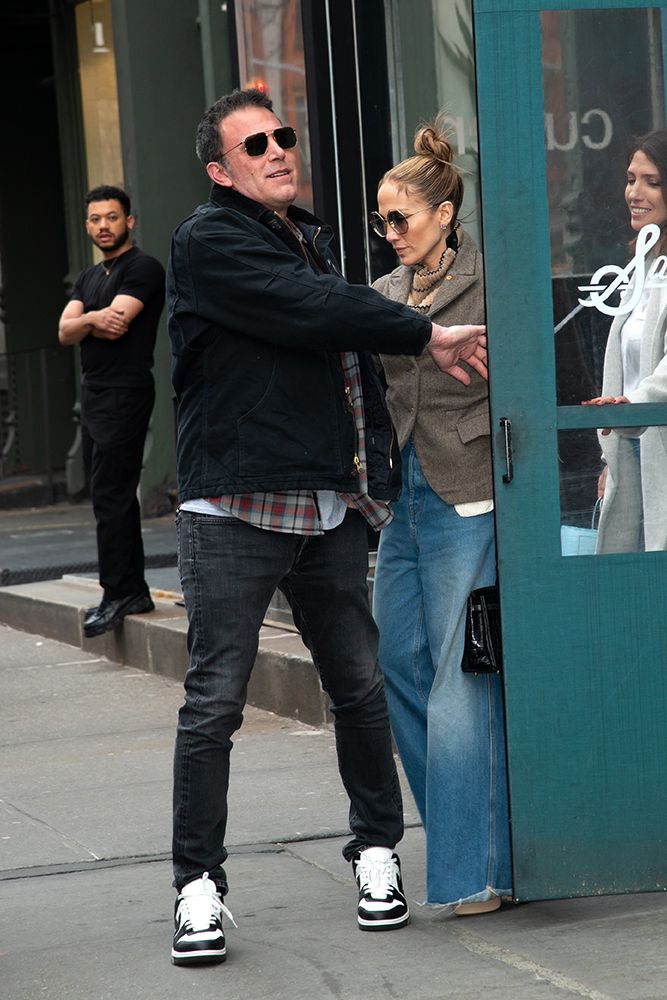 Ben Affleck holding the door of Sadelle's open for Jennifer Lopez