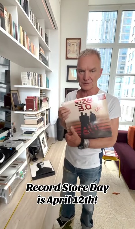 Sting holding up vinyl while standing in his NYC apartment