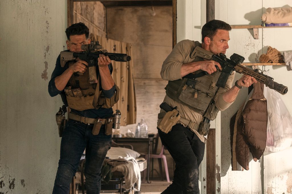two men running with guns