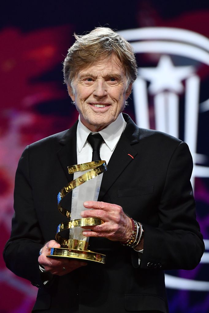 Robert Redford holds one of his many awards