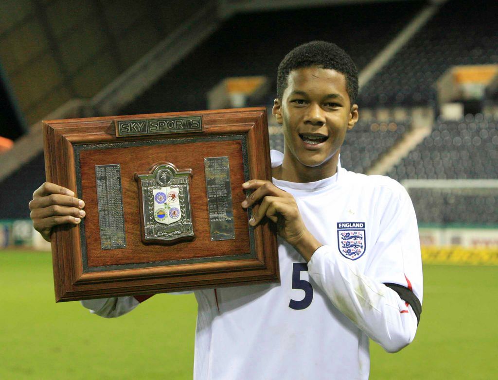 England captain Jordan Spence  holds aloft the Sky Victory Shield in 2005