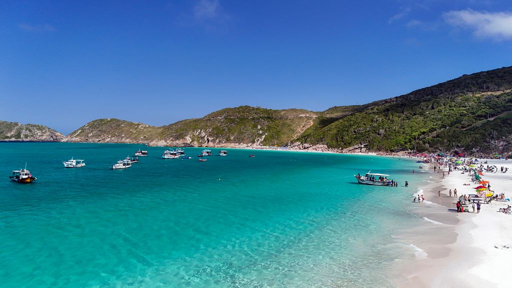 Aerial view of Pontal do Atalaia Beach in Arraial do Cabo, Rio de Janeiro, Brazil on a sunny day with blue sky
