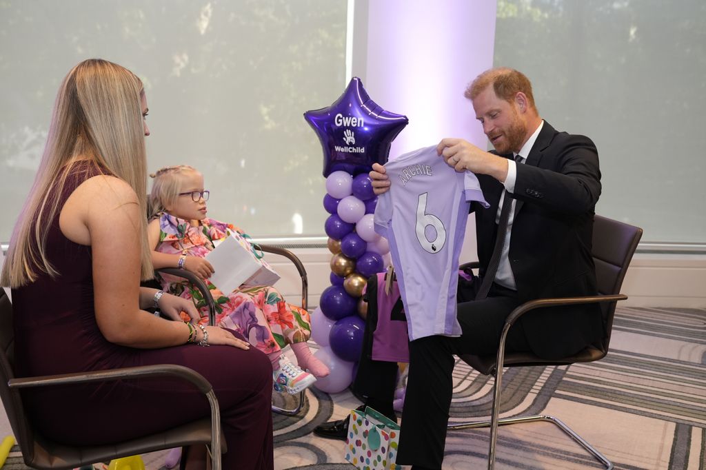 Harry is gifted a Brighton and Hove Albion football shirt for his son Prince Archie from nine-year-old Gwen
