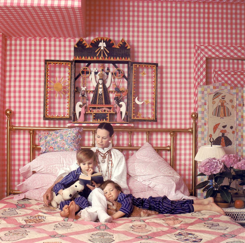 Socialite and heiress  Gloria Vanderbilt poses for a portrait session with her sons Anderson Cooper (left) and Carter Vanderbilt Cooper on a bed in their home on March 30, 1972 in Southampton, Long Island, New York