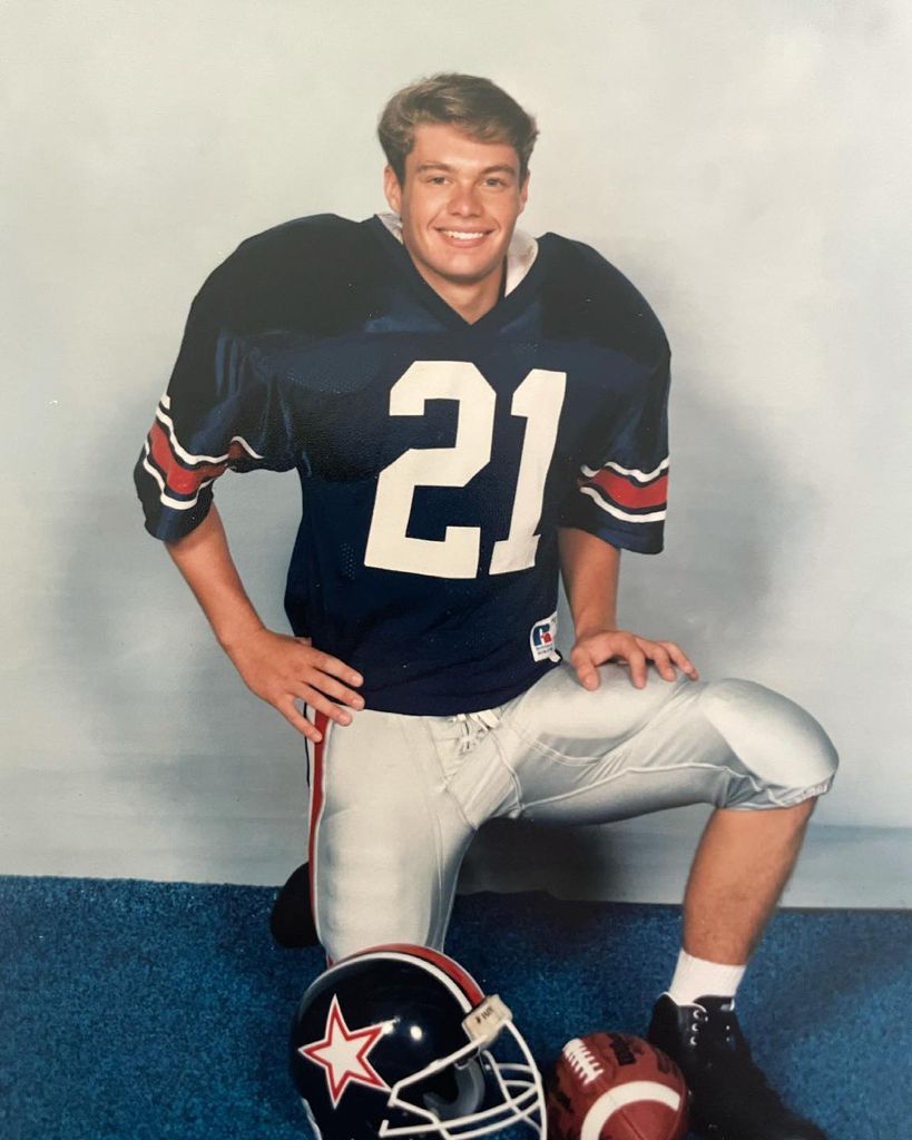 Ryan Seacrest poses in his football kit in high school