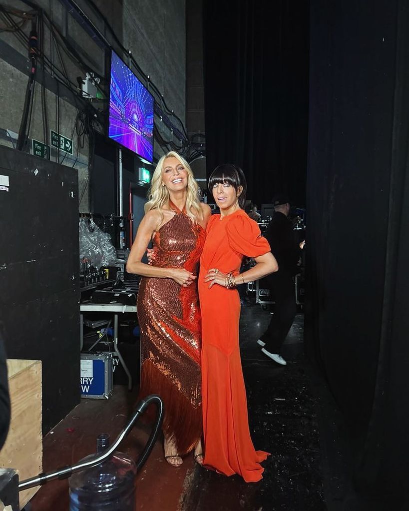 Claudia in a orange dress backstage with claudia