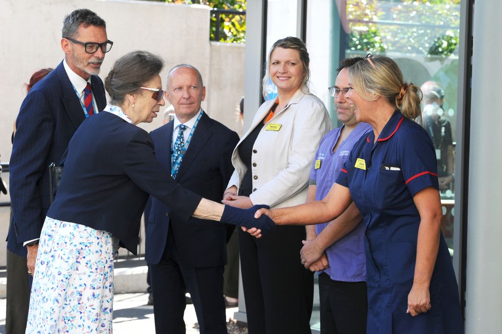 Princess Anne wearing gloves and sunglasses to shake hands with healthcare workers