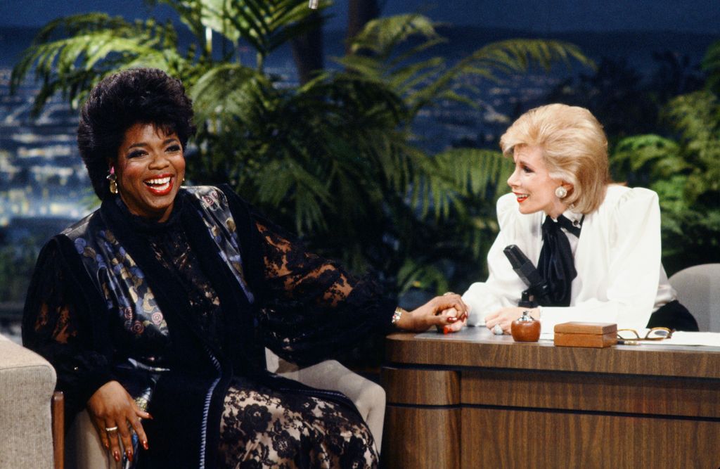 THE TONIGHT SHOW STARRING JOHNNY CARSON -- Pictured: (l-r) Talk show host Oprah Winfrey during an interview with guest host Joan Rivers on January 27, 1986 -- (Photo by: Paul Drinkwater/NBCU Photo Bank/NBCUniversal via Getty Images via Getty Images)