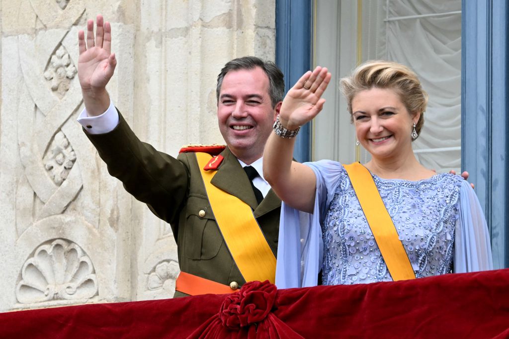 Luxembourg's Grand Duke Guillaume and Duchess Stephanie wave from the balcony of the Grand Ducal Palace
