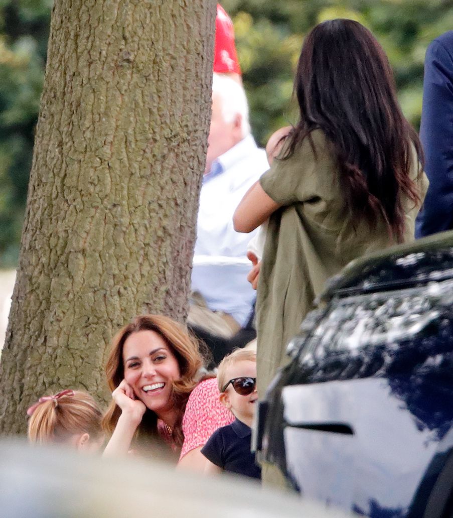 Kate laughs at Louis wearing sunglasses as Meghan holding Archie looks on