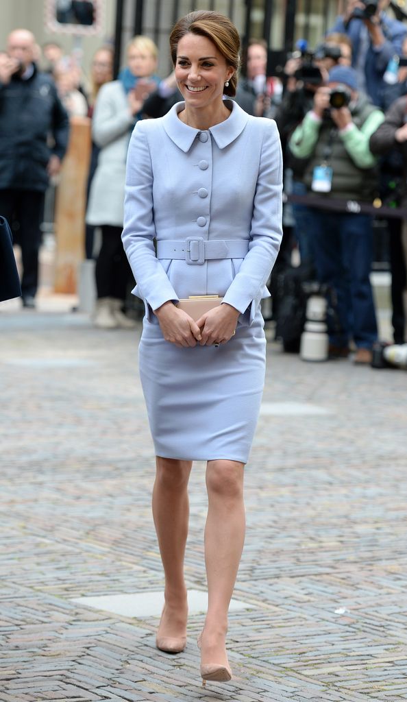 Kate in peplum top and pencil skirt in blue with hair up