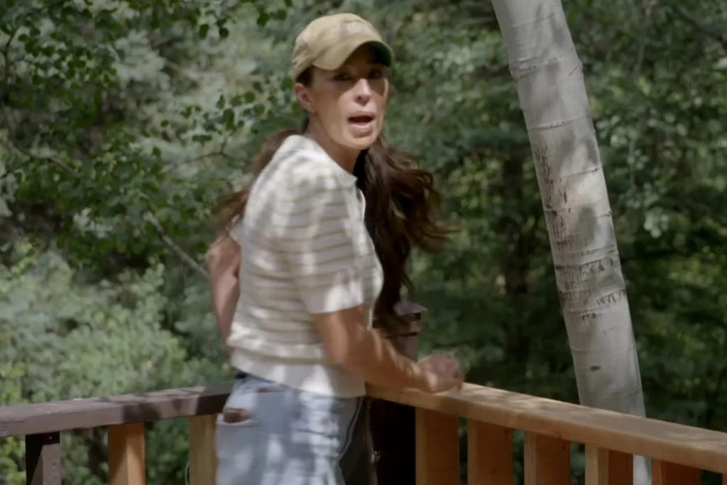 photo taken from teaser of joanna gaines on a balcony filming fixer upper colorado mountain house