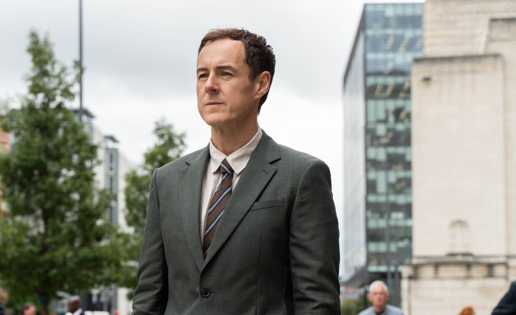 man in suit standing outdoors
