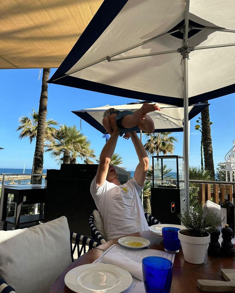 Andy Murray lifts his son Teddy above his head