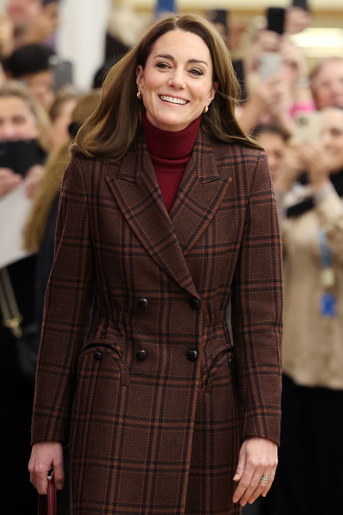 Kate Middleton walking in a brown plaid coat